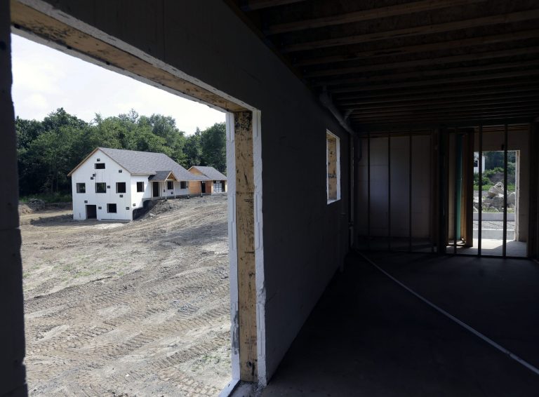   FILE - In this Tuesday, July 9, 2013, file photo, a zero net energy home under construction is seen from the interior of another at The Preserve at Mountain Vista in New Paltz, N.Y. The Commerce Department reports the pace at which builders broke ground on homes in July on Friday, Aug. 16, 2013. (AP Photo/Mike Groll, File)  