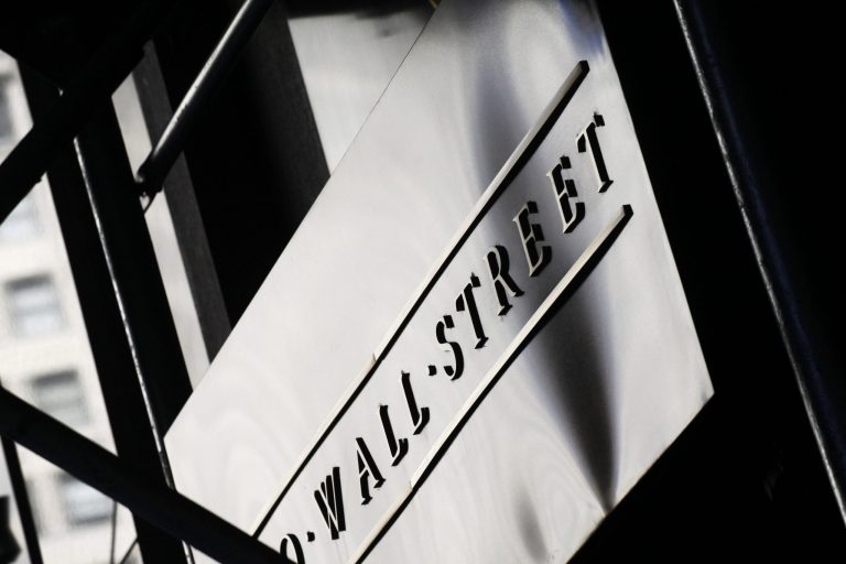 FILE - This July 15, 2013 file photo shows a sign for Wall Street outside the New York Stock Exchange, in New York. Global stock markets overcame a contraction in Japan's economy and jitters about Ukraine and Iraq to mostly rise Wednesday, but analysts said new geopolitical developments would likely make for volatile trading. (AP Photo/Mark Lennihan, File)