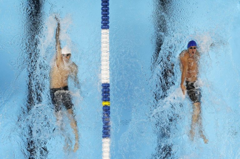 Michael Phelps, left, and Ryan Lochte swim in the men's 400-meter individual medley final at the U.S. Olympic swimming trials, Monday, June 25, 2012, in Omaha, Neb. Lochte won the race. (AP Photo/Mark Humphrey)