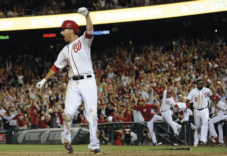 Patrick McDermott/Getty Images
First baseman Adam LaRoche celebrates after scoring the game-winning run in his team's win over the Mets on Tuesday.