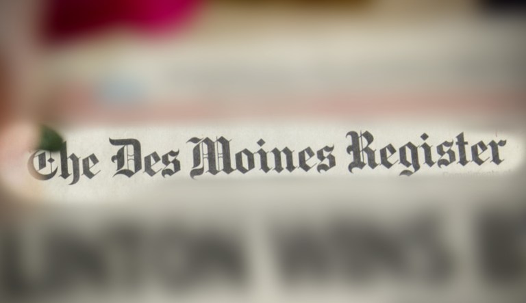 A 1992 Des Moines Register newspaper is seen with a blur effect emphasizing the newspaper's name.