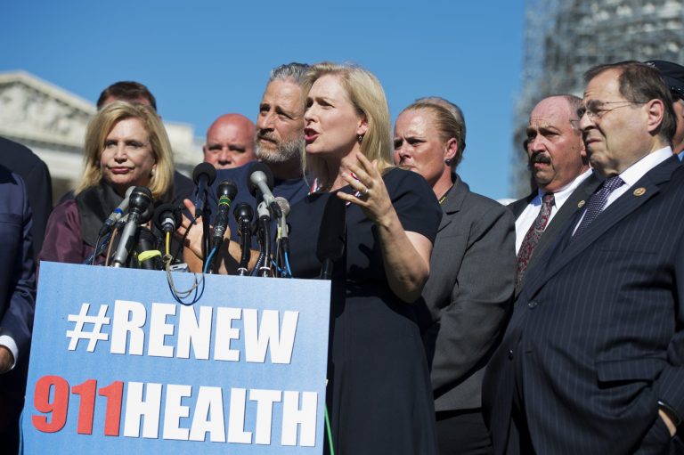 Sen. Kirsten Gillibrand, D-N.Y., and Jon Stewart, behind her, attend a rally on the East Front of the Capitol with members of the FDNY to urge Congress to extend healthcare benefits for first responders who suffer from cancer and other ailments as a result of their work at ground zero after the 9/11 attacks. (CQ Roll Call via AP)