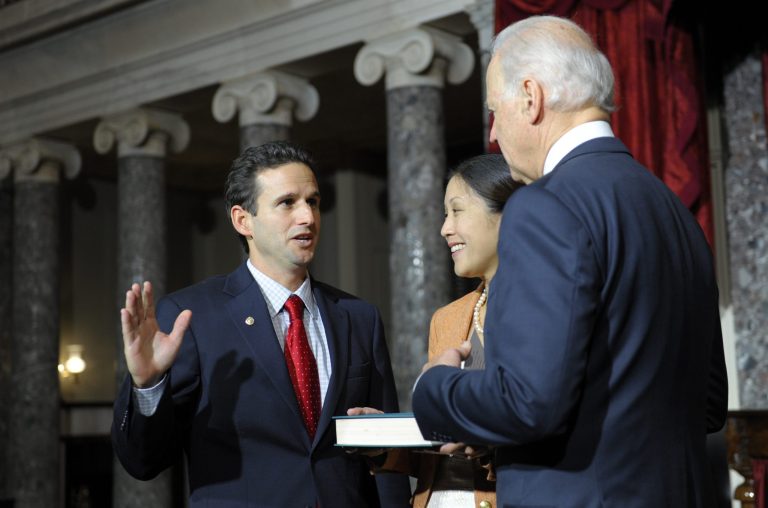   Vice President Joe Biden, right, re-enacts the swearing in of Sen. Brian Emanuel Schatz, D-Hawaii., left, as wife Linda Schatz, holds the bible and watches at center, during a ceremony in the Old Senate Chamber on Capitol Hill in Washington, Thursday, Dec. 27, 2012. Hawaii Gov. Neil Abercrombie named Schatz, his lieutenant governor, to fill the Senate seat left vacant following the death of the late Sen. Daniel Inouye, D-Hawaii. Earlier, Biden officially administered the Senate oath to Schatz on the Senate floor. (AP Photo/Susan Walsh)  