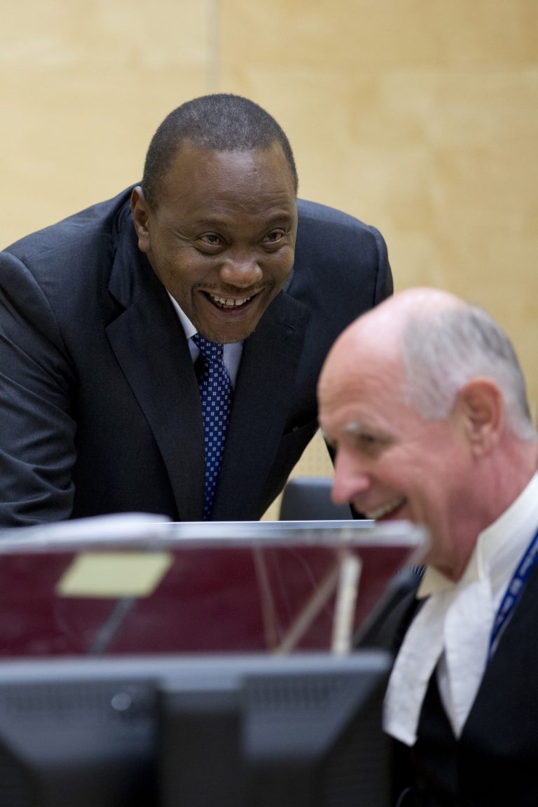 Kenya's president Uhuru Kenyatta talks to his lawyer Steven Kay, right, when appearing before the International Criminal Court in The Hague, Netherlands, Tuesday Oct. 8, 2014, to appeal for the crimes against humanity case against him to be dropped for lack of evidence. Kenyatta, who this week temporarily handed the presidency to his deputy to avoid becoming the first sitting head of state to appear at the court, says prosecutors have insufficient evidence to merit putting him on trial for allegedly instigating violence after Kenya's 2007 presidential elections that left more than 1,000 people dead. Prosecutors concede that they don't have enough evidence, but argue that Kenyan authorities are blocking their investigation. (AP Photo/Peter Dejong, Pool)