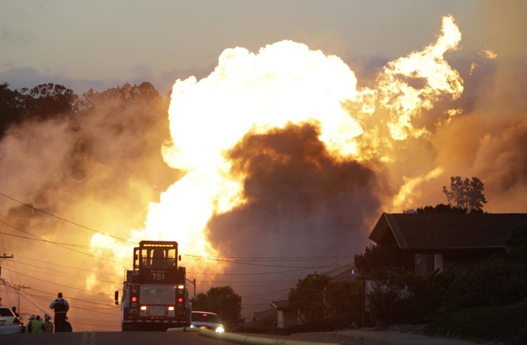 File - In this Sept. 9, 2010 file photo, a massive fire roars through a mostly residential neighborhood in San Bruno, Calif. California regulatory judges issued a $1.4 billion penalty on Tuesday, Sept. 2, 2014 against the state's largest utility for a lethal 2010 gas pipeline explosion that engulfed a suburban San Francisco neighborhood in flames, killing eight people and prompting national alerts about the oversight of aging pipelines. (AP Photo/Paul Sakuma, File)
