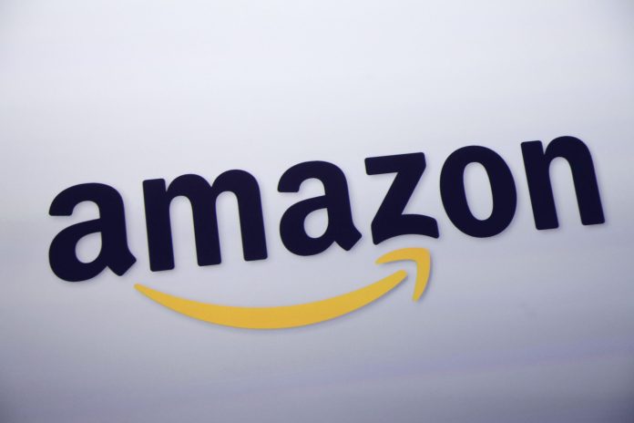 FILE - This Sept. 28, 2011 file photo shows the Amazon logo on display at a news conference in New York. Rumors of an Amazon smartphone reached a fever pitch this week, with several tech blogs speculating that the device could be due out this year.