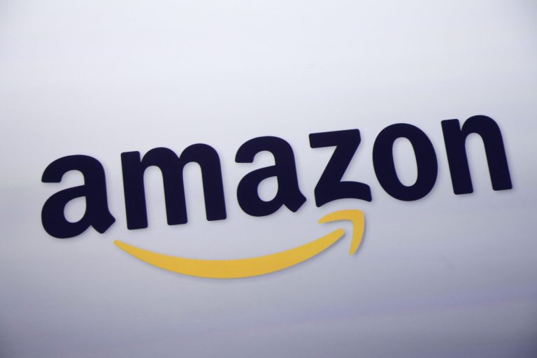 FILE - This Sept. 28, 2011 file photo shows the Amazon logo on display at a news conference in New York. Rumors of an Amazon smartphone reached a fever pitch this week, with several tech blogs speculating that the device could be due out this year.