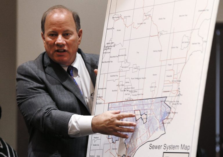 Detroit Mayor Mike Duggan discusses a sewer system map during a news conference in Detroit Tuesday, Sept. 9, 2014. The Detroit water department would be turned into a regional agency with a 10-year limit on rate increases and an infusion of millions of dollars from the suburbs, under a deal announced the mayor and other officials. (AP Photo/Paul Sancya)