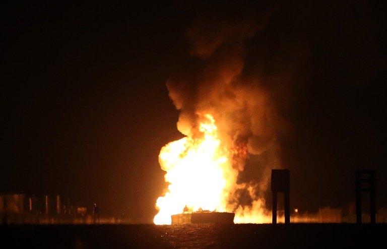 A tugboat and barge are engulfed in flames after hitting a natural gas pipeline in Bayou Perot about two miles south of lower Lafitte, Louisiana, Tuesday, March 12, 2013. Four people were injured one person was severely burned and was being treated at West Jefferson Medical Center. (AP Photo/Michael DeMocker, Nola.com | The Times-Picayune)