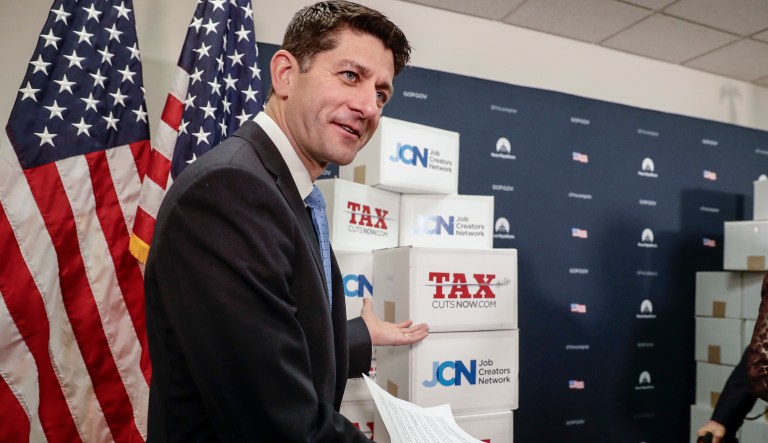 Speaker of the House Paul Ryan, R-Wis., points to boxes of petitions supporting the Republican tax reform bill that is set for a vote later this week as he arrives for a news conference on Capitol Hill in Washington, Tuesday, Nov. 14, 2017.