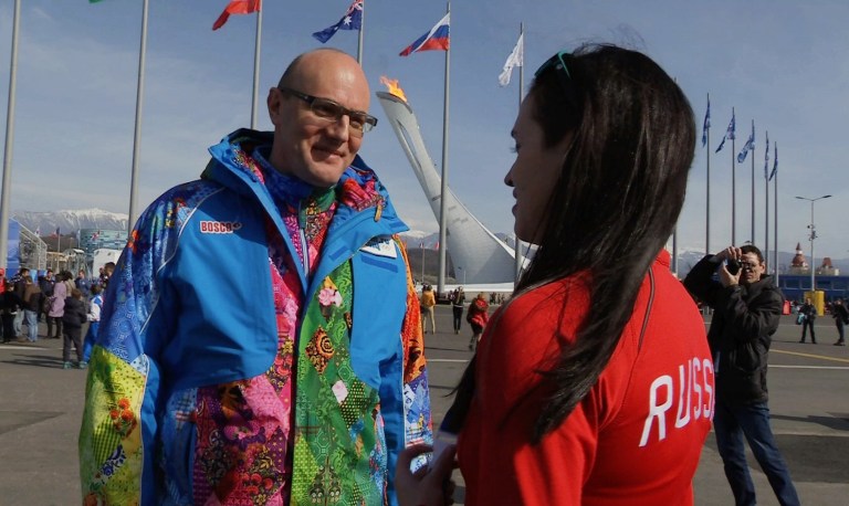 Sochi 2014 Organizing Committee President Dmitry Chernyshenko, left, talks to a Russian fan during a tour of Olympic Park at the 2014 Winter Olympics, in Sochi, Russia on Thursday, Feb. 20, 2014. (AP Photo/Ben Jary)
