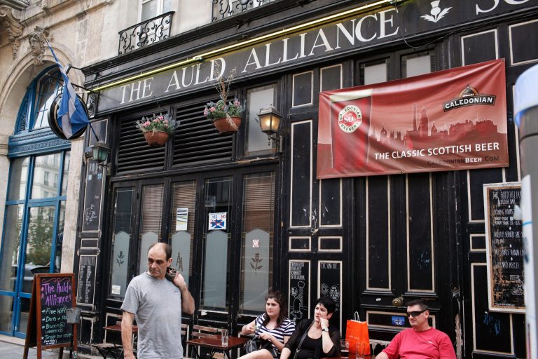 People walk past the Scottish pub 