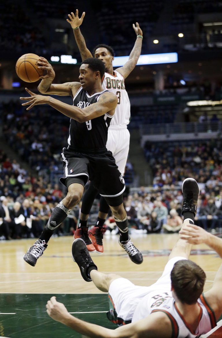   Brooklyn Nets' MarShon Brooks (9) looks to pass between Milwaukee Bucks' Brandon Jennings (3) and Beno Udrih during the first half of an NBA basketball game, Wednesday, Dec. 26, 2012, in Milwaukee. (AP Photo/Morry Gash)  