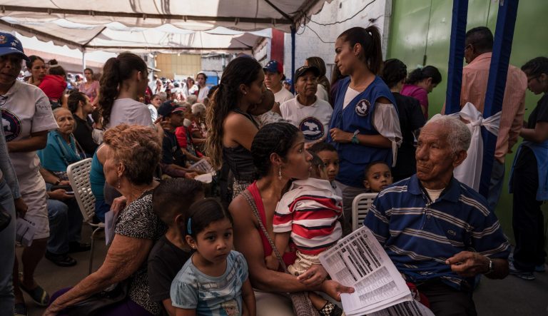 Residents wait at a volunteer humanitarian aid camp set up for medical treatments in the Macarao neighborhood of Caracas, Venezuela, on Sunday, Feb. 17, 2019.