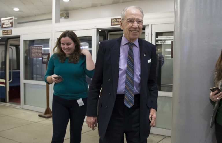 Senate Judiciary Committee Chairman Chuck Grassley, R-Iowa, foreground, who also sits on the tax-writing Senate Finance Committee, heads to the Senate floor for votes on Capitol Hill in Washington, Monday, Nov. 27, 2017. President Donald Trump and Senate Republicans are scrambling to change a Republican tax bill in an effort to win over holdout GOP senators and pass a tax package by the end of the year. (AP Photo/J. Scott Applewhite)