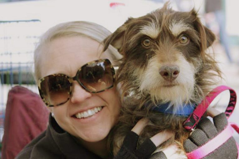 This undated photo provided by Dallas Pets Alive shows Leslie Sans with dog Ethan during an adoption event held in Dallas. Dallas Pets Alive, a non-profit with 12 main volunteers and a pool of 50 foster homes, runs the rescue out of Sans' home. The non-profit's new social media campaign takes Instagram photos of both the celebrities and edits in a dog in need, often attaching humorous captions urging adoptions. (AP Photo/Dallas Pets Alive, Leslie Sans)