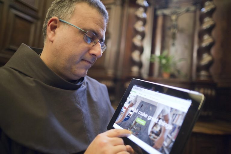 The head of the Franciscan convent of St. Francesco a Ripa, Friar Stefano Tamburo, uses a tablet device to check the Kickstart page promoting the conservation works required in the cell that St. Francis of Assisi is believed to have used when visiting the convent in Rome, Friday, Feb. 28, 2014. The friars who run the St. Francis a Ripa church in Rome's Trastevere neighborhood are launching a Kickstarter online fundraising campaign Tuesday, March 11, 2014, to try to raise the $125,000 to restore the tiny cell where St. Francis stayed when he came to Rome to see the pope, The Associated Press has learned. Rather than ask for funding from the Italian government, which owns the church and is responsible for its upkeep, the friars decided on this more democratic crowdfunding initiative thinking it more in keeping with the Franciscan tradition of seeking alms for just what they need, spreading the faith as they beg, and making sure the poor are the priority. (AP Photo/Domenico Stinellis)