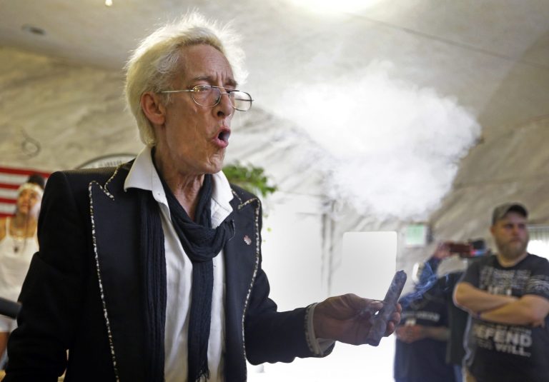 First Church of Cannabis Founder Bill Levin exhales as he smokes a 