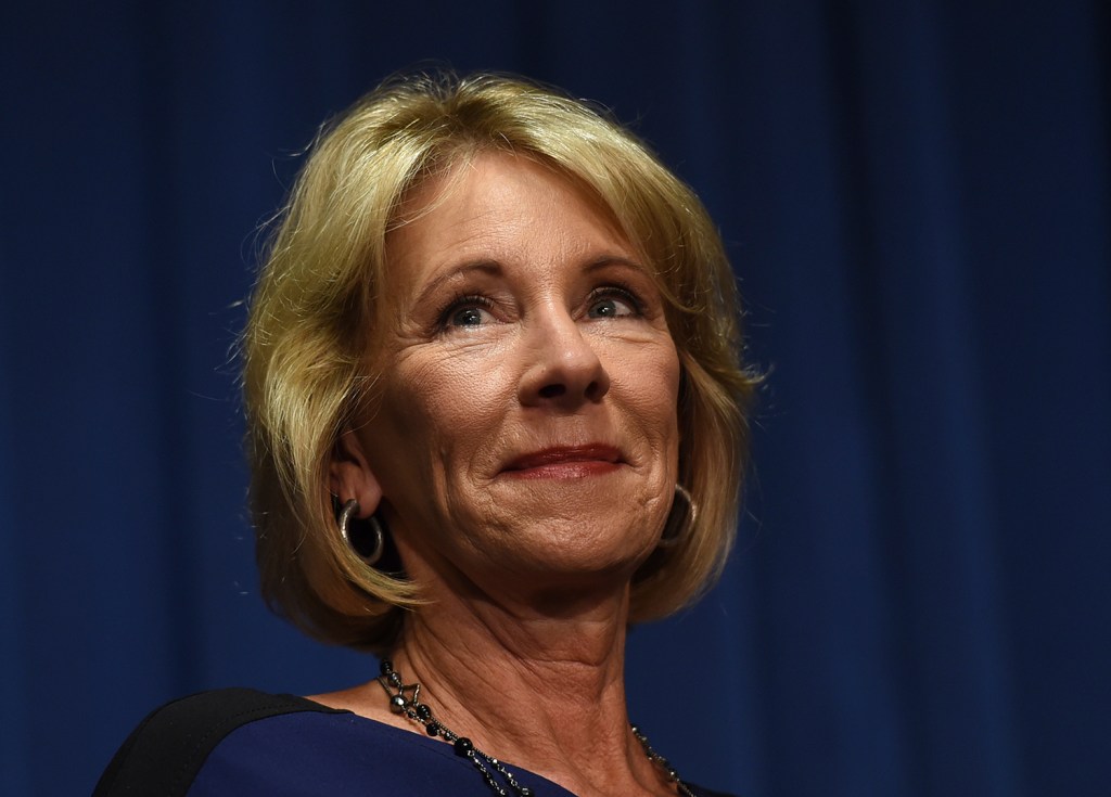 Protester held a Black Lives Matter sign while keeping DeVos from meeting with a 94% black school