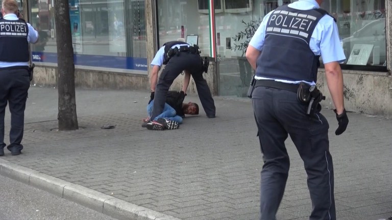 In this grab taken from video, police arrest a man in Reutilingen, Germany. (NONSTOP NEWS via AP)