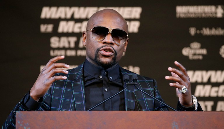 It's time to quit the complaining and enjoy the spectacle of Floyd Mayweather vs. Conor McGregor. At its core, this Saturday night's main event will be a fist-fight between prize fighters at the top of their games. Two men squaring off with nothing but eight-ounce gloves over their hands. (AP Photo/John Locher)