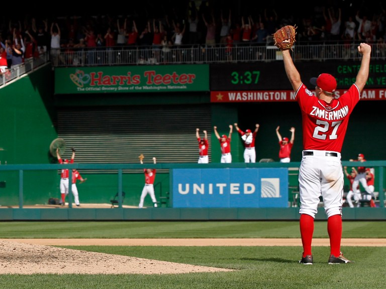 Washington Nationals starting pitcher Jordan Zimmermann (27) celebrates, as do players in the bullpen, after the last out in Zimmermann's no-hitter in a baseball game against the Miami Marlins at Nationals Park, Sunday, Sept. 28, 2014, in Washington. The Nationals won 1-0. (AP Photo/Alex Brandon)