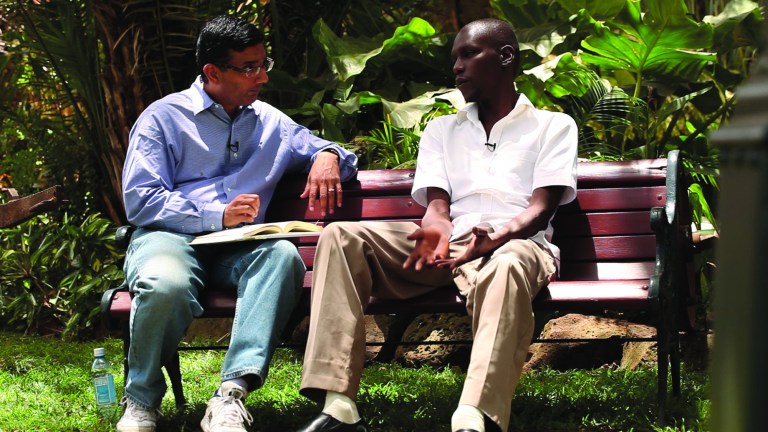 This publicity image released by Rocky Mountain Pictures, shows an undated film clip of director, Dinesh D'Souza, interviewing George Obama in 