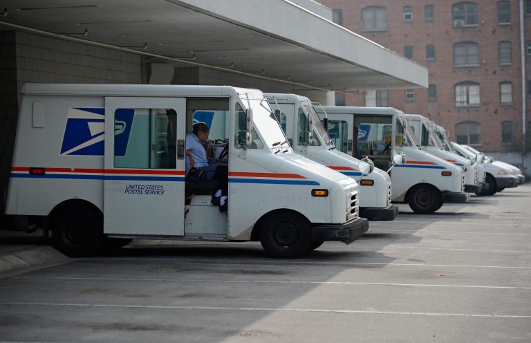 A U.S. Postal service employee loads his van as he prepares to leave the loading dock to deliver mail from the Los Feliz Post Office on February 6, 2013 in Los Angeles, California. (Photo by Kevork Djansezian/Getty images)