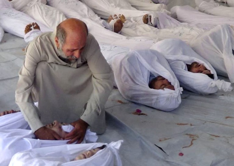 FILE - In this Wednesday, Aug. 21, 2013, file citizen journalism image provided by the Media Office Of Douma City, which has been authenticated based on its contents and other AP reporting, a Syrian man mourns over a dead body after an alleged poisonous gas attack fired by regime forces, according to activists, in Douma town, Damascus, Syria. Humanitarian group Doctors Without Borders said Saturday, Aug. 24, 2013,  some 355 people showing 
