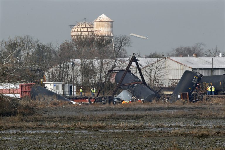   FILE - In this Friday, Nov. 30, 2012 file photo, officials work the scene of derailed freight train tank cars in Paulsboro, N.J. Residents of Paulsboro were ordered to stay inside and schools were closed Monday, Dec. 3, 2012, after unsafe levels of the chemical vinyl chloride were found in the air near where the train derailed last week. (AP Photo/Mel Evans, File)  