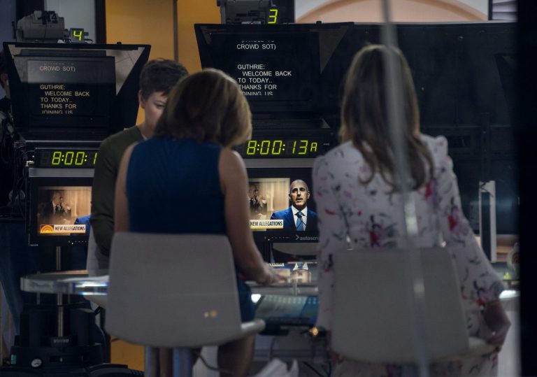 Co-anchors Hoda Kotb, center left, and Savannah Guthrie, right, sit on the set during a news segment of 