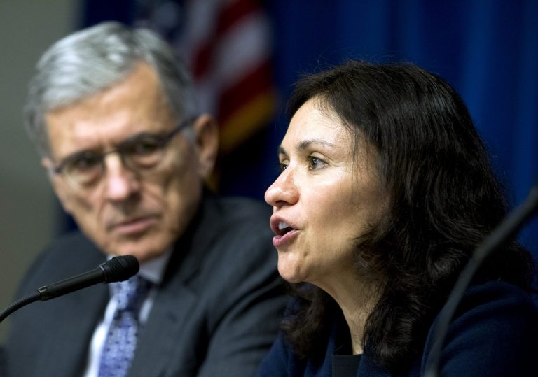 Federal Communications Commission (FCC) Chairman Tom Wheeler listens at left as Federal Trade Commission (FTC) Chair Edith Ramirez speaks during a new conference in Washington, Wednesday, Oct. 8, 2014, to announce that AT&T will pay $80 million to FTC for consumer refunds in mobile cramming case,  which is part of combined $105 million settlement with FTC and FCC. ( AP Photo/Jose Luis Magana)