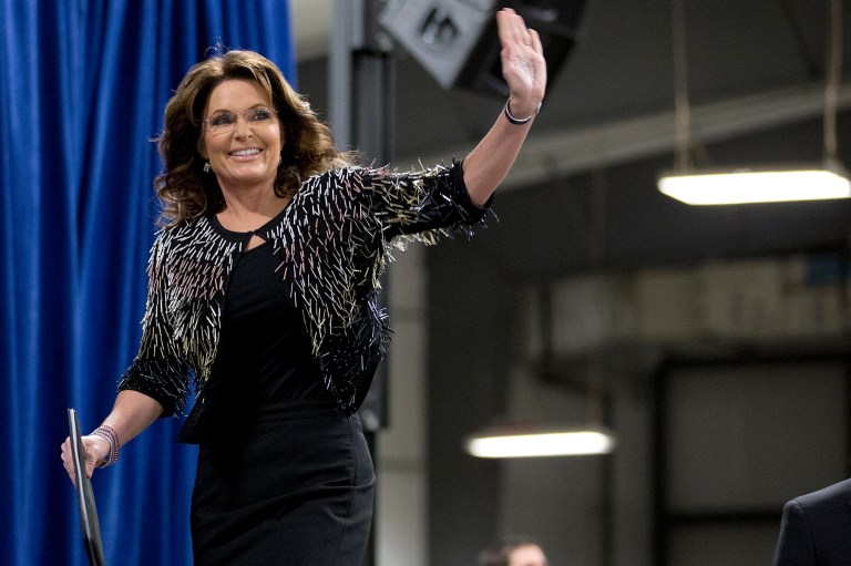 Former Alaska Gov. Sarah Palin waves as she arrives on stage to endorse Republican presidential candidate Donald Trump during a rally at the Iowa State University. (AP Photo/Mary Altaffer)
