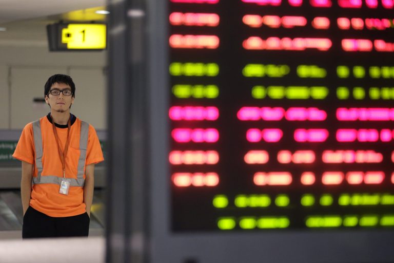 In this photo from Thursday, July 10, 2014, Irwin Carbajal, 23, a aircraft cabin cleaner, poses for a photograph at Newark Liberty International Airport in Newark, N.J. Carbajal, who makes $8.25 an hour, is hoping to benefit from a pay increase which the Service Employees International Union is pushing for. (AP Photo/Julio Cortez)