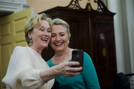 FOR USE AS DESIRED, YEAR END PHOTOS - FILE - In this Dec. 1, 2012 file photo, Actress Meryl Streep uses her iPhone to get a photo of her and Secretary of State Hillary Rodham Clinton following the State Department Dinner for the Kennedy Center Honors gala at the State Department in Washington. (AP Photo/Kevin Wolf, File)