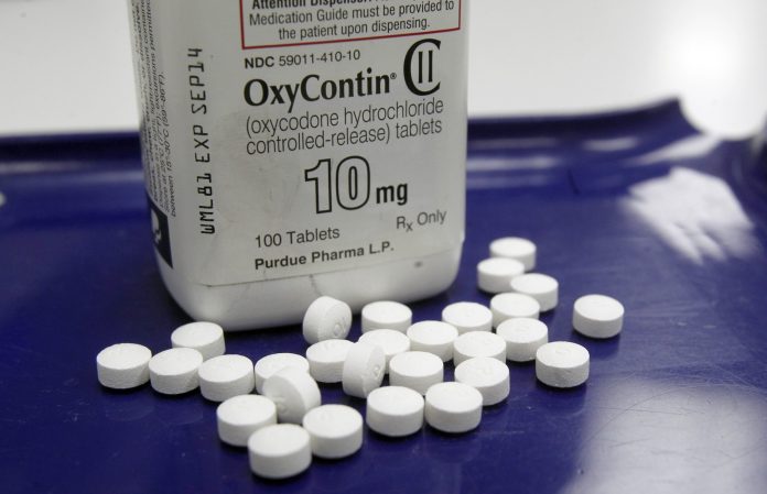 OxyContin pills are arranged for a photo at a pharmacy in Montpelier, Vt. on Tuesday, Feb. 19, 2013. (AP Photo/Toby Talbot)