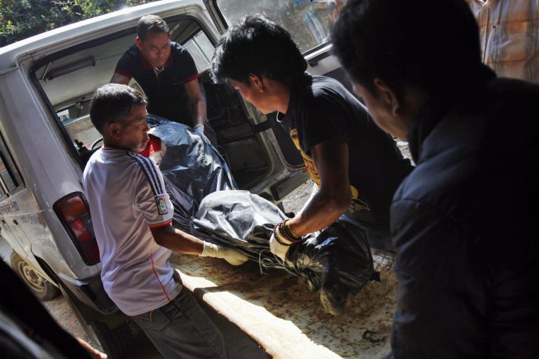 Hospital personnel with the help of the relatives of the avalanche victims, shift the body of a victim onto a stretcher at a morgue at Teaching Hospital in Katmandu, Nepal, Monday, Oct. 20, 2014. Nepal was wrapping up rescue operations in its northern mountains Monday, saying all the hikers believed to have been stranded on a trekking route by a series of deadly blizzards are now safe. (AP Photo/Niranjan Shrestha)
