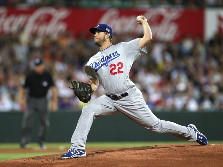 The Dodgers' Clayton Kershaw throws his first pitch of the Major League Baseball 2014 season during the opening game between the Los Angeles Dodgers and Arizona Diamondbacks at the Sydney Cricket ground in Sydney, Saturday, March 22, 2014.  (AP Photo/Rick Rycroft)
