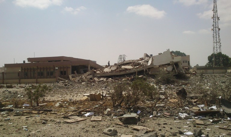 A man stands on the rubble of the main building of the security headquarters that was collapsed after an attack by Islamic hard-line militias in Benghazi, Libya, Friday, Aug. 1, 2014. Islamic hard-line militias, including the group accused by the United States in a 2012 attack that killed the ambassador and three other Americans, claimed control of Libya's second largest city, Benghazi, after overrunning army barracks and seizing heavy weapons. (AP Photo)