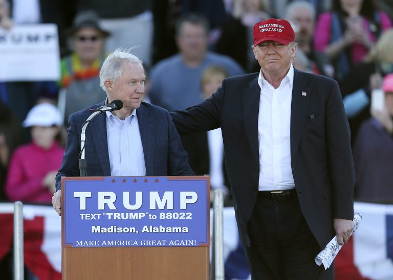 Republican presidential candidate Donald Trump, right, stands next to Sen. Jeff Sessions, R-Ala. Both believe uncontrolled immigration hurts U.S. wages. (AP Photo/John Bazemore)