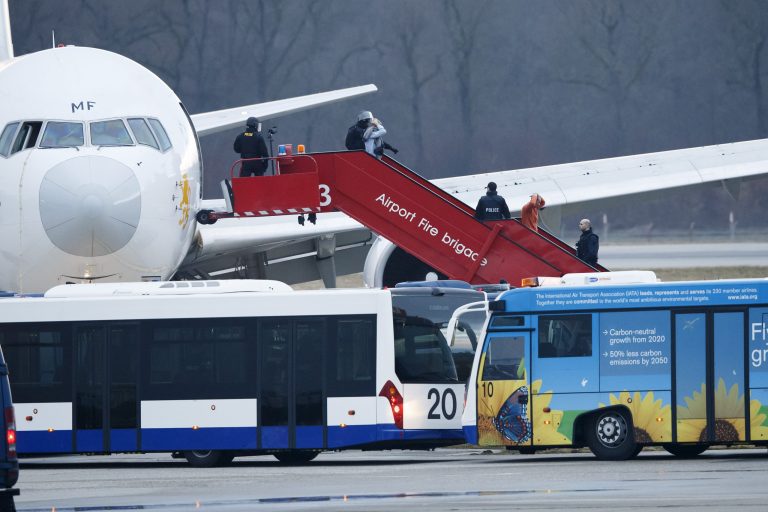 Police stand on the stairs after passengers were evacuated from a hijacked Ethiopian Airlines Plane on the airport in Geneva, Switzerland, Monday, Feb. 17, 2014. A hijacked aircraft traveling from Addis Abeda, Ethiopia, to Rome, Italy, has landed at Geneva's international airport early Monday morning. Swiss authorities have arrested the hijacker. (AP Photo/Keystone, Salvatore Di Nolfi)