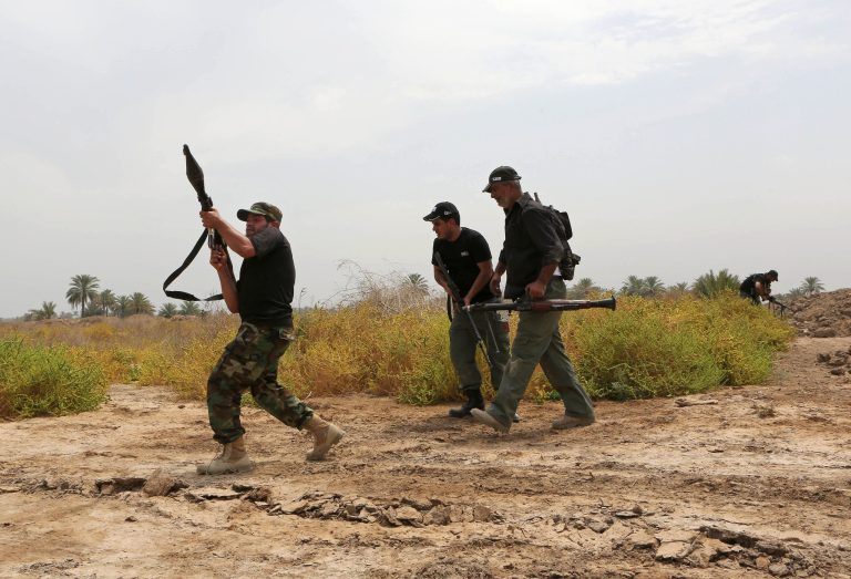 Iraq Shiite fighters make their way to the front line to fight militants from the extremist Islamic State group in Jurf al-Sakhar, 43 miles (70 kilometers) south of Baghdad, Iraq, Monday, Aug 18, 2014. Fighters of the voluntary armed group formed after the radical Shiite cleric Muqtatda al-Sadr called to protect holy shrines against possible attacks by Sunni militants. (AP Photo/ Hadi MIzban))