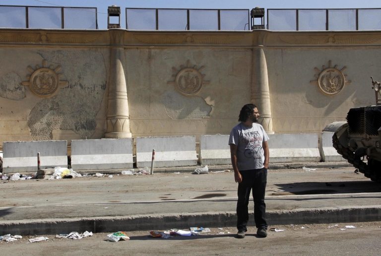 Prominent Egyptian blogger Alaa Abdel-Fattah stands in front of a criminal court in Cairo, Egypt, Wednesday, June 11, 2014. A court has convicted Abdel-Fattah for demonstrating without permit and assaulting a policeman, sentencing him to 15 years in prison. (AP Photo/Heba Elkholy, El Shorouk Newspaper) EGYPT OUT