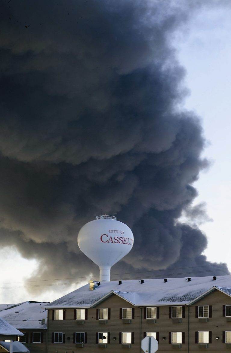 FILE - In this Dec. 30, 2013 file photo, a fireball goes up at the site of an oil train derailment in Casselton, N.D. The 911 dispatch recordings from the fiery derailment show initial confusion about the cargo on board. The recordings show that a member of the train crew first told emergency dispatchers in Fargo that it was hauling ethanol. The substance actually was highly flammable crude oil from western North Dakota. Eighteen cars on the 106-car oil train derailed and several exploded and burned. (AP Photo/Bruce Crummy, File)