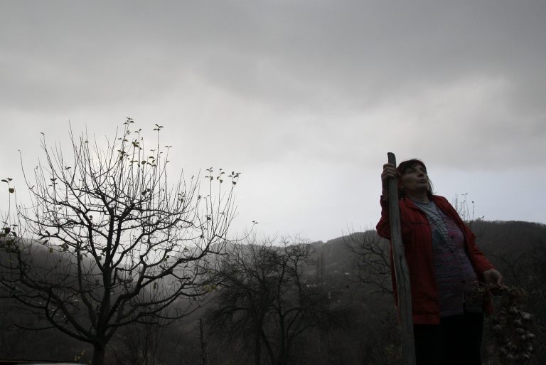   In this Nov. 30, 2012 photo Milka Prokic is seen at twilight with a garland of garlic and a wooden stake, in the village of Zarozje, near the Serbian town of Bajina Basta. Get your garlic, wooden crosses and stakes ready: a bloodsucking vampire is on the loose. Or so say villagers in the tiny western Serbian hamlet of Zarozje, nestled between the lush green mountain slopes and spooky thick forests. Rumors that a legendary vampire ghost has returned are spreading panic throughout the town. An official warning telling villagers to put garlic in their pockets and place wooden crosses in each of their rooms, the tools that should keep away the vampires did nothing but fuel the fear. (AP Photo/Darko Vojinovic)  