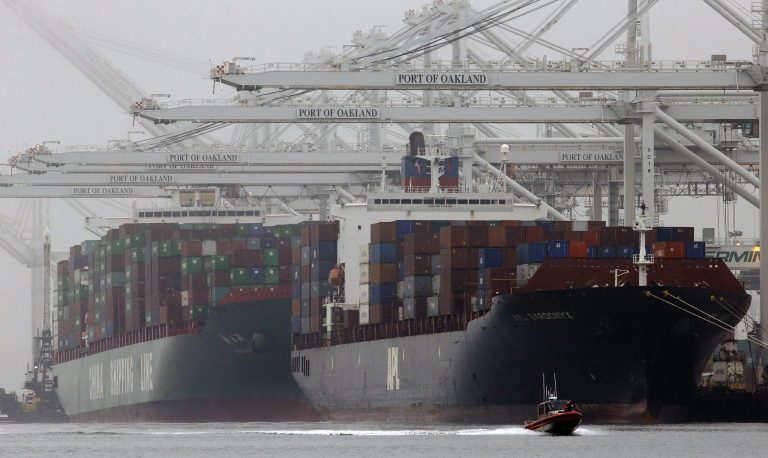 FILE -  In this Wednesday, Oct. 23, 2013, file photo, container ships wait to be off-loaded at the Port of Oakland in Oakland, Calif. The contract that keeps workers on the job at 29 West Coast ports expires on Tuesday, July 1, 2014. Both sides have said not to expect a deal, and that they will continue to bargain. (AP Photo/Ben Margot, File)