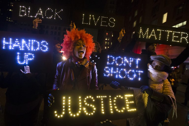 A demonstrator chants during a rally in downtown Manhattan in New York. In the past three weeks, grand juries have decided not to indict officers in the chokehold death of Eric Garner in New York and the fatal shooting of Michael Brown in Ferguson, Mo. The decisions have unleashed demonstrations and questions about police conduct and whether local prosecutors are the best choice for investigating police. (AP Photo/John Minchillo)