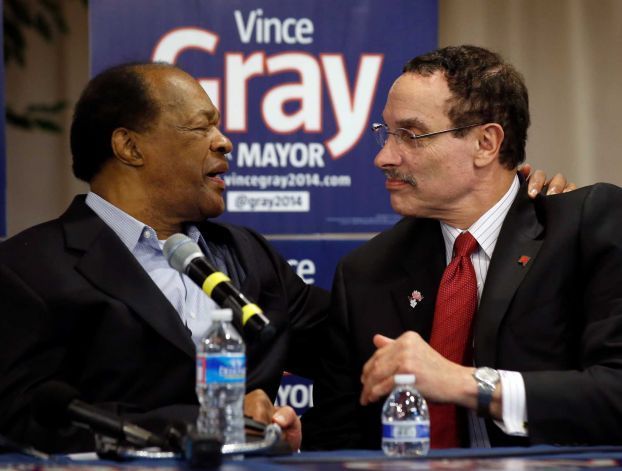 Former Washington, D.C., mayor and current city councilmember Marion Barry, left, embraces Mayor Vincent Gray during a media availability to announce Barry's endorsement of Gray's re-election bid in Washington on Wednesday. (Alex Brandon, AP)