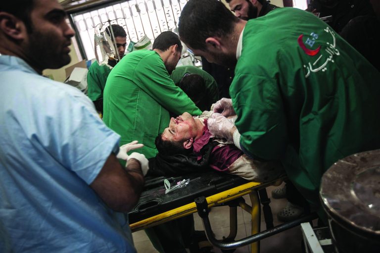 In this Wednesday, Nov. 14, 2012 photo, a Syrian resident gets emergency medical attention as he arrives to a hospital after he was injured by a mortar attack in Aleppo, Syria. (AP Photo/Narciso Contreras)