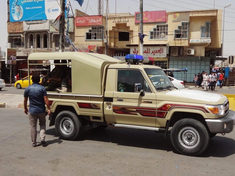 Kurdish security forces deploy in the oil-rich city of Kirkuk, 180 miles (290 kilometers) north of Baghdad, Iraq, Friday, June 13, 2014. Iraqi officials say al-Qaida-inspired militants who this week seized much of the country's Sunni heartland have pushed into an ethnically mixed province northeast of Baghdad, capturing two towns there. The writing on the metal shutters at left advertises a shop for sale. (AP Photo/ Emad Matti)